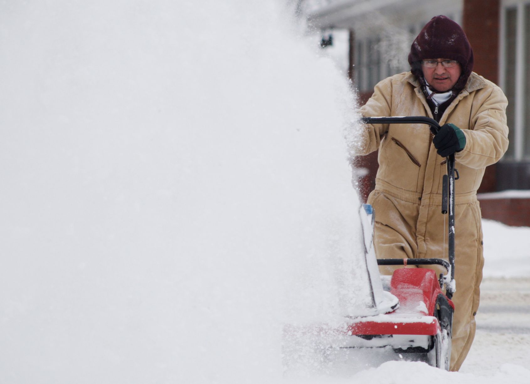 Patrick Choriki clears the sidewalk